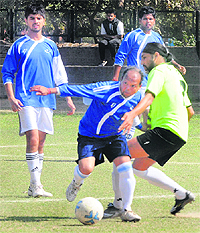 Players vie for the ball during the Senior Men Football Championship at the Football Stadium, Sector 17, Chandigarh. 