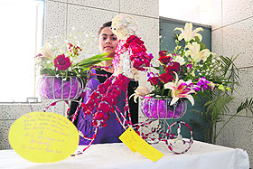 A girl admires a flower arrangement at Dr MS Randhawa Golden Jubilee Flower Show and Competition at the PAU in Ludhiana on Friday.