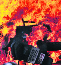 A vehicle set ablaze in Bangalore on Friday. 