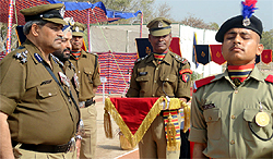 DIG, BSF, Vimal Satyarthi honouring a newly-recruited soldier for performing meritoriously during the passing out parade