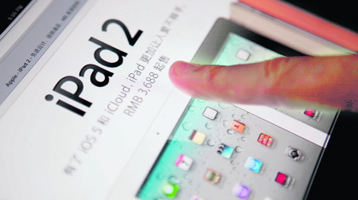 A man touches the screen of an an Apple Inc's iPad in this photo illustration on Saturday. Lawyers for Apple Inc. argued for its right to use the iPad trademark in China on Wednesday, as a higher court began a crucial hearing that could result in sales of the popular tablet computer being halted throughout the Chinese mainland.