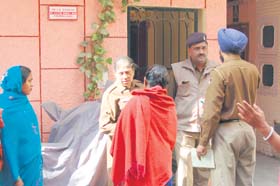 Police officials outside the deceased’s house at Sector 56, Chandigarh, on Saturday
