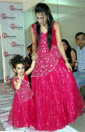 A little girl walks down the ramp with her designer at Fashionista Fashion Fest  Kids Couture 2012 in Gurgaon on Saturday. 