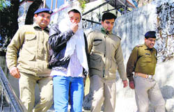 Ravi Malik, one of the accused in the shooting case of BSP candidate from Mussoorie Manoj Sharma, comes out of a police station after interrogation in Mussoorie