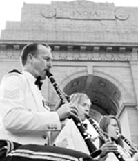 The British Royal Air Force Regiment Band performs with the Indian Air Force's Air Warriors Symphony Orchestra during a joint outdoor concert at the India Gate in New Delhi