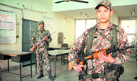 Paramilitary forces guard a strong room at Raizada Hans Raj Stadium, where EVMs have been kept after Assembly polls, in Jalandhar.