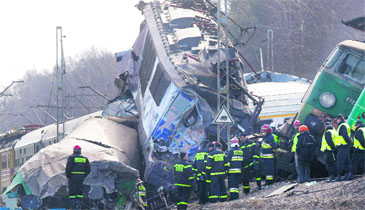 Rescuers work at the scene of a train crash in Szczekociny, Poland