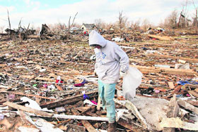 A man searches through debris in Marysville, Indiana, on Sunday
