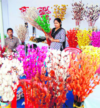 Visitors look at artificial flowers at All-India crafts bazaar in Amritsar.