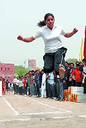 A girl shows her prowess in the long jump event.
