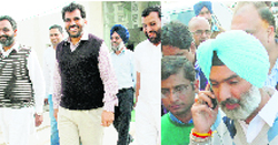 SAD candidate NK Sharma with his supporters comes out of his office at Zirakpur on Monday; and Independent candidate Deepinder SIngh Dhillon talks on his mobile phone at Zirakpur. 