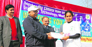 A winner in the girls section of the quarter marathon receives a cash prize from HS Chahal, Vice-Chancellor of the Deenbandhu Chhotu Ram University of Science and Technology in Murthal. 