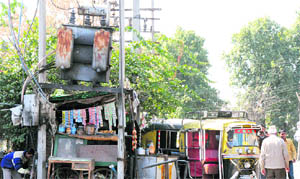 A makeshift shop under a transformer near Karan Tal Park on the Railway Road in Karnal.