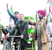 Balwant Singh Mankotia, state president, J&K National Panthers Party, takes part in a cycle rally in Jammu on Monday .