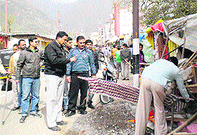 Shopkeepers remove goods after the MC launched an anti-encroachment drive in Katra on Monday.