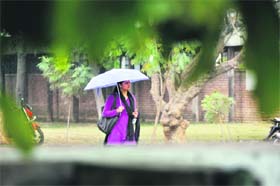 A girl enjoys rain in Ludhiana on Monday