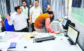 Policemen take a look at the CCTV footage on the State Bank of India premises in Ludhiana on Monday