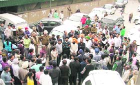 Residents and political leaders gather outside the MC Zone A office after meeting the MC Commissioner in Ludhiana on Monday
