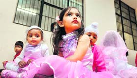 Students await their turn during the annual function of Bachapan Playway School in Ludhiana