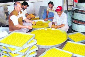 Workers prepare ‘laddoos’ at a shop in Ludhiana