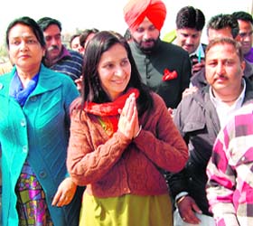 BJP candidate from Amritsar East Dr Navjot Kaur Sidhu, flanked by her husband MP Navjot Singh, greets supporters in Amritsar on Tuesday