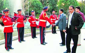 Deputy Commissioner Rajat Aggarwal shakes hand with members of the police band at Company Bagh in Amritsar