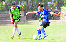 Players in action during the match between Panjab University Campus and Principal AG (Audit) Haryana at the Football Stadium in Sector 17 of Chandigarh on Tuesday.