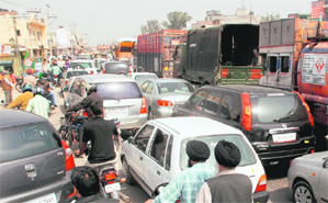 A view of a traffic jam caused by the victory procession of SAD candidate NK Sharma on the highway at Dera Bassi on Tuesday.