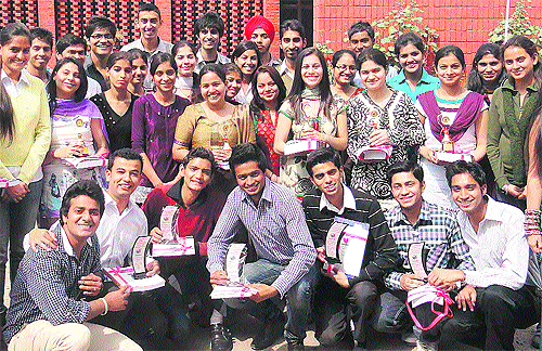 Students pose after receiving prizes at the Government College of Commerce and Business Administration at Sector 42 in Chandigarh on Tuesday. 