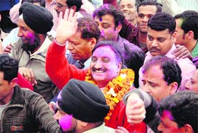 Former Chief Minister and senior BJP leader Ramesh Pokhriyal Nishank celebrates his victory in Dehradun on Tuesday