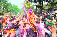 BJP candidate Madan Kaushik celebrates his victory in the Assembly elections in Haridwar on Tuesday. 