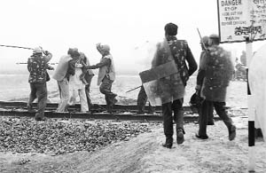  Cops use force to move a Jat protester from the railway track at Gajuwala on Fatehabad on Tuesday. 