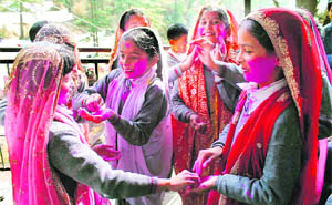 Children play with colours ahead of Holi in Shimla.