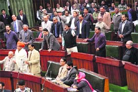 Legislators from opposition parties protest in the Assembly on Tuesday