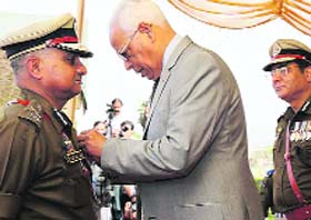 Governor NN Vohra presents the Presidents Medal to a police officer in Jammu on Tuesday