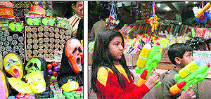 Masks on display; and (right) children select waterguns at a shop at the Pacca Danga market in Jammu. 