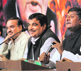 BJP president Nitin Gadkari (C), with party leaders Ravi Shankar Prasad (R) and Ananth Kumar, smiles during a press conference in New Delhi on Tuesday. 