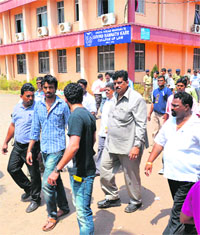 MP and Congress member Churchill Alemao (2R) leaves a counting centre in Margao, Goa, on Tuesday