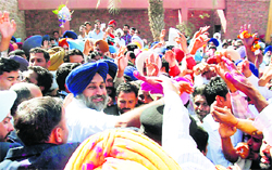 Supporters greet SAD president Sukhbir Singh Badal outside his residence at Badal village in Muktsar district.