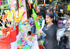 A girl selects a squirt gun on the eve of Holi, at Dhobi Bazar in Bathinda on Wednesday.
