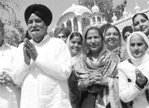 Nirmal Singh, newly elected MLA from Bassi Pathana, comes out of the Amab Sahib gurdwara with his wife and supporters on Wednesday. 