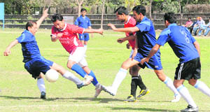 Players vie for the ball during a match of the Chandigarh Senior Mens Football Championship at the Sector-17 stadium in Chandigarh on Wednesday. 