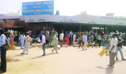 People wait for buses at Jhajjar bus stand.