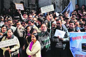 Members of the Computer Teachers Association raise slogans against the government in Shimla on Wednesday.