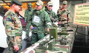NDRF team members explain the working of the equipment used to deal with CBRN disasters during an exhibition in Jalandhar on Wednesday. 