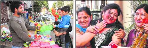 A woman buys a water gun; and (right) women play Holi at Chhoti Baradari in Jalandhar on Wednesday. 