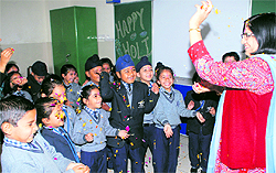 Students of Bal Bharti School celebrate pushp Holi in Ludhiana on Wednesday