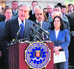 FBI Director Robert Mueller with Christine Levinson (R), wife of former FBI agent Robert Levinson in Washington. 