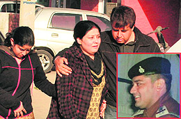A wailing sister of sub-inspector Vishal (inset), who allegedly committed suicide at Sector 42 in Chandigarh on Friday.