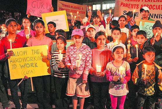 CLTA trainees take part in a candle march in Sector 17, Chandigarh, on Friday. 